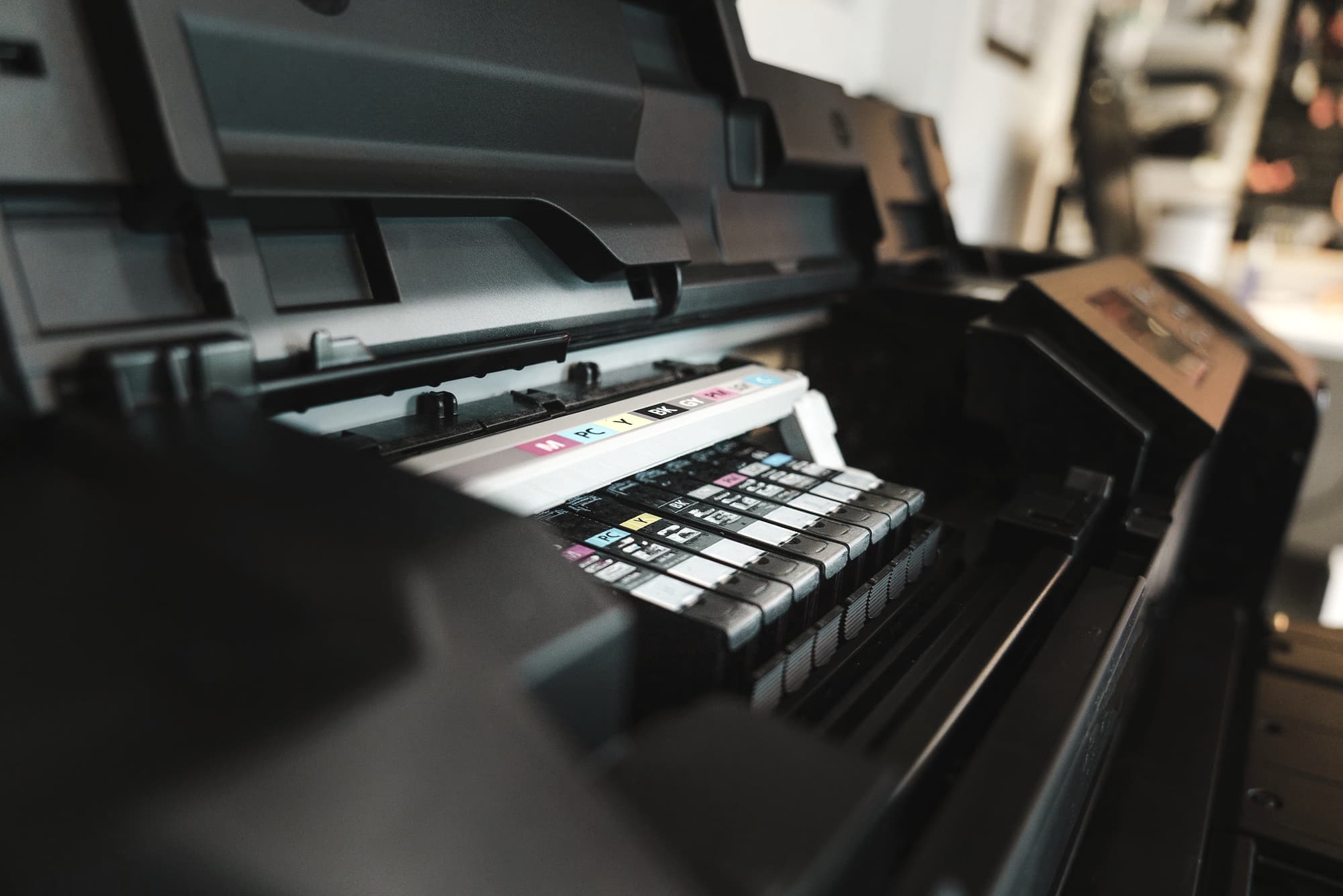 Close view of ink reservoirs inside an inkjet printer in a bright room